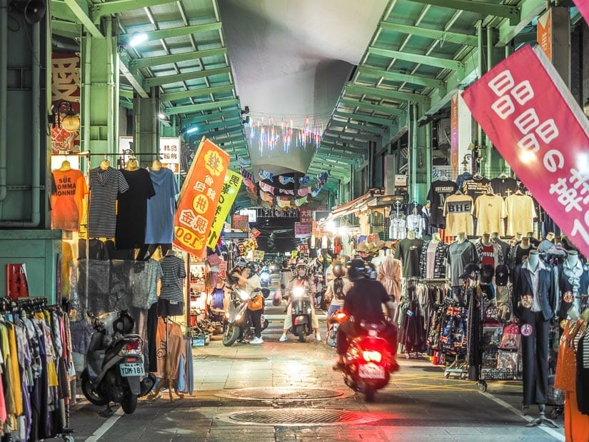 A scooter driving through Nanhua Night Market in Kaohsiung