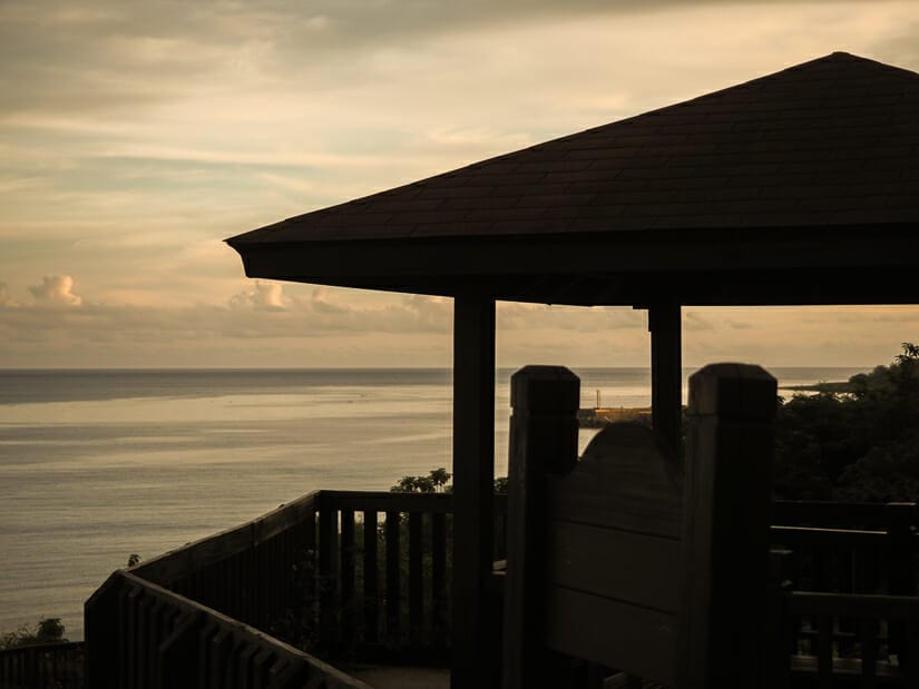 Orange sky with a lookout platform in silhouette and ocean in background at Sunrise Pavilion, Little Liuchiu Island