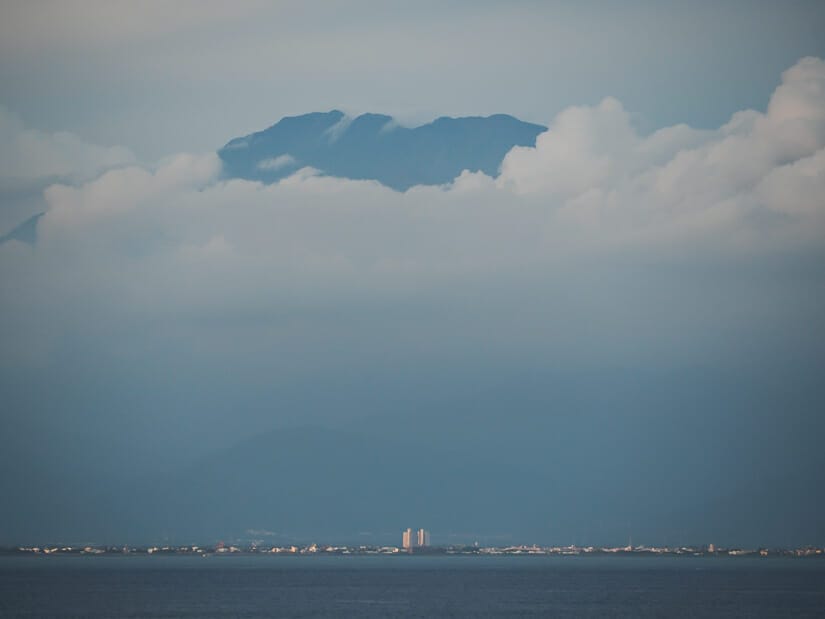 The coast of taiwan and a mountain poking out from the clouds viewed from Xiaoliuqiu Island