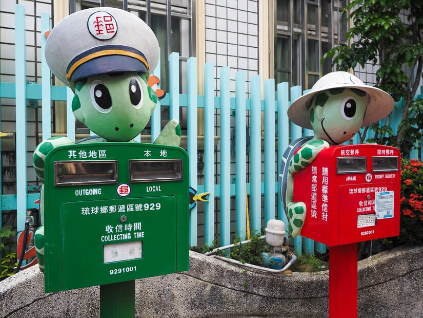 Two Taiwanese post office boxes in Xiao Liu Qiu Island, one green and one red, and each with a cute turtle statue on it