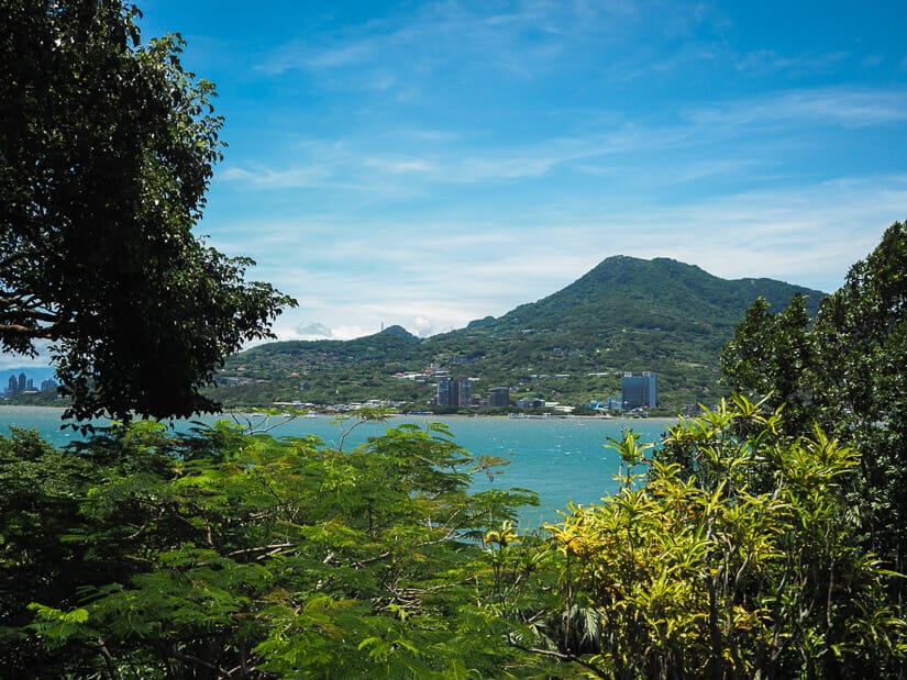 Danshui river viewed between the trees from Fort San Domingo, with Guanyin Mountain across the river
