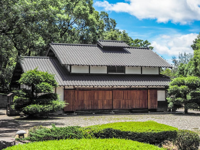 Exterior of a Japanese wooden building in Tamsui called Drop of Water Memorial Hall, with landscaped gardens around it