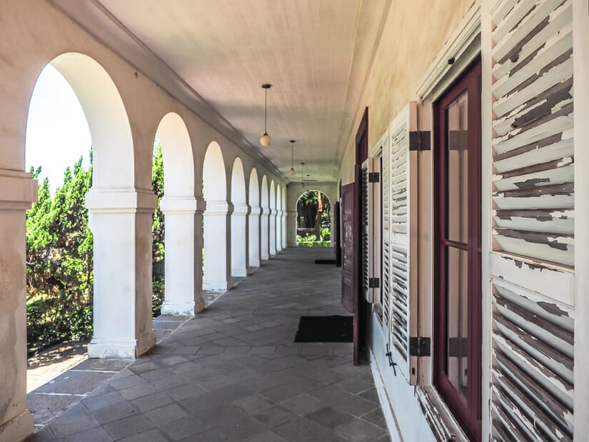 A long patio with white arches and wooden windows at Tamsui Customs Officers’ Residence