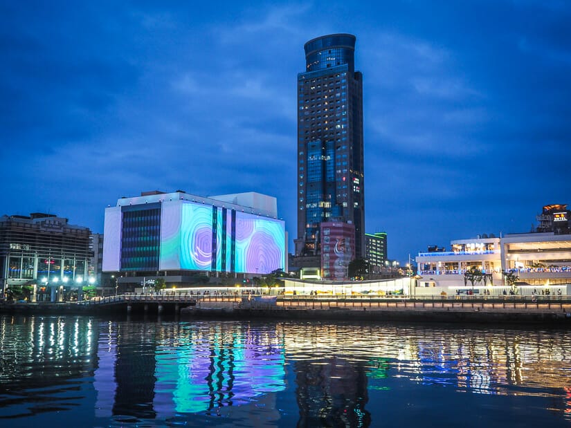 Keelung harbor at night, with some buildings lit up fronting the water