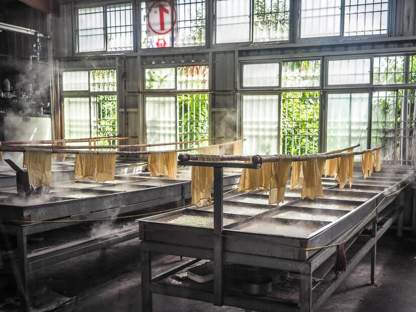 A row of steaming vats with tofu skins hanging to dry in Chishang