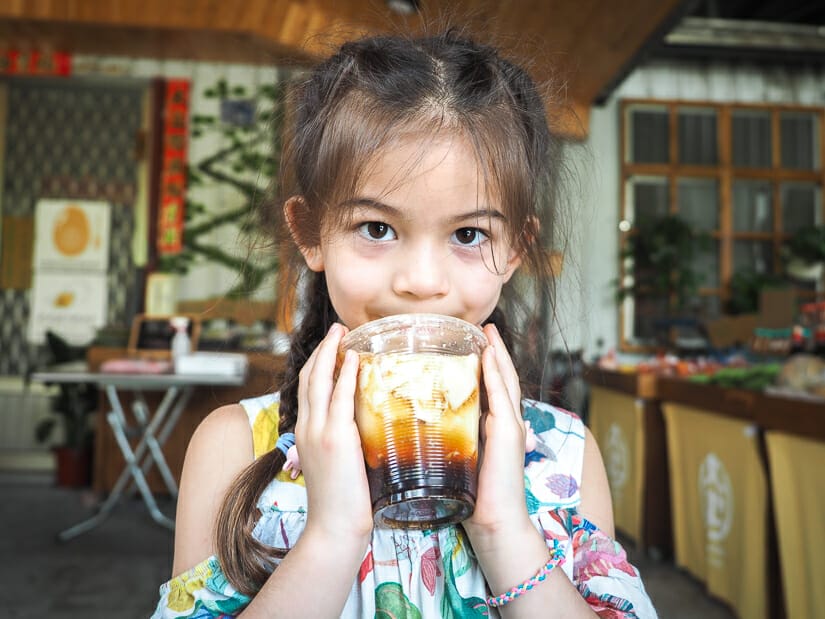 A young girl holding a cup of douhua in a Chishang restaurant