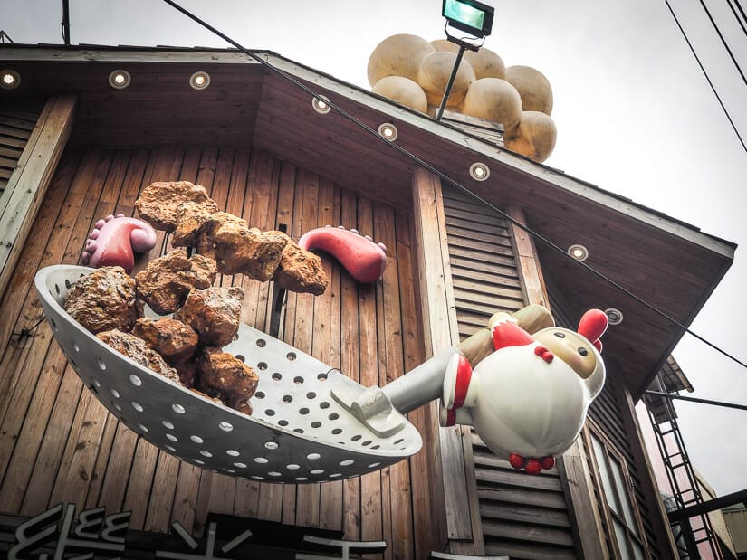 A 3D sculpture of chicken chunks being fried on the side of a wall in Fengchia Night Market in Taichung