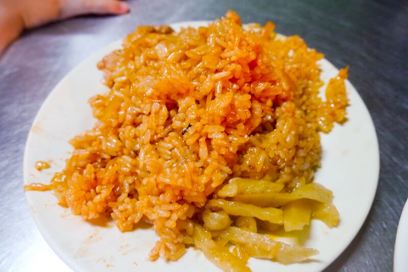 A white plate with ketchup fried rice on it in Zhonghua Road Night Market