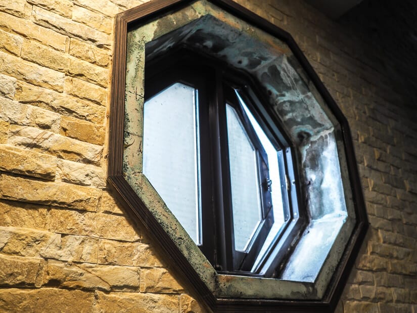 Close up of an octagonal framed window on a brick wall inside Starbucks Keelung Yi 14 branch