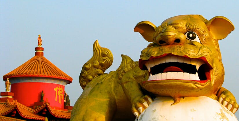 A giant lion statue and temple structure at Zhongzheng Park in Keelung