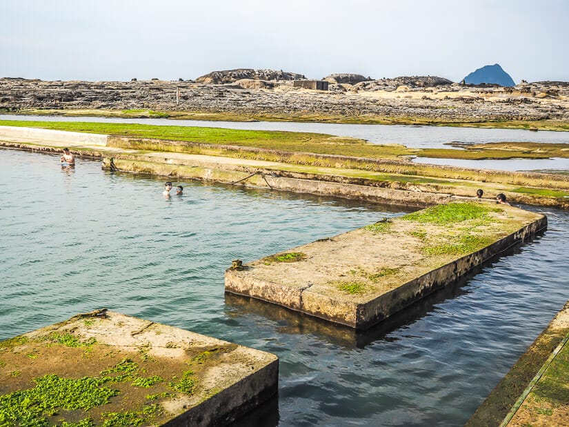 Two kids kids swimming in a natural seawater pool at Heping Island Park in Keelung