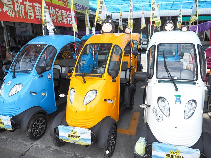 Some electric vehicles for rent in Chishang that look like mini tuk tuks and with Totoro on top