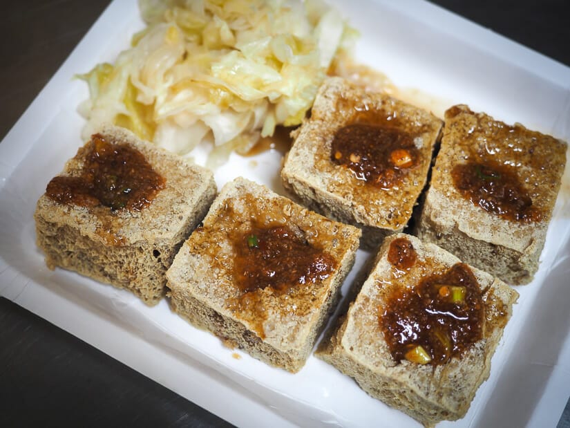A white paper plate with 5 large cubes of stinky tofu in Yizhong Night Market Taichung