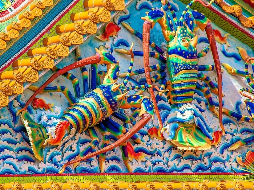 Huge colorful lobster designs on the side of a temple in Penghu
