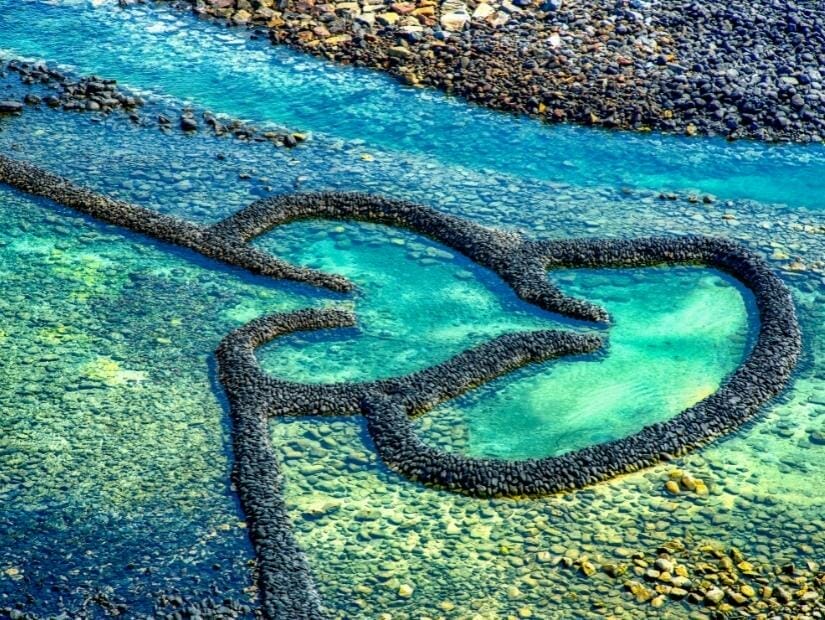 A stone weir in the sea that's shaped like two hearts, a famous site on Qimei (Chimei) island in Penghu