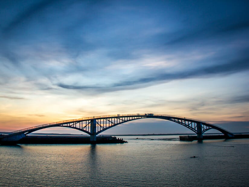 Long, curving Rainbow Bridge in Penghu at sunset viewed from Guanyinting