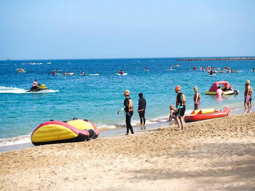A beach in Penghu with people doing various water activities on it