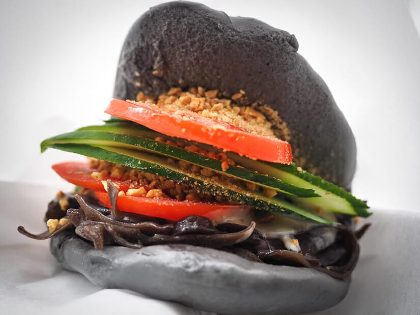 A vegetarian guabao, or Taiwanese hamburger, with gray colored sesame bun, in Ximending