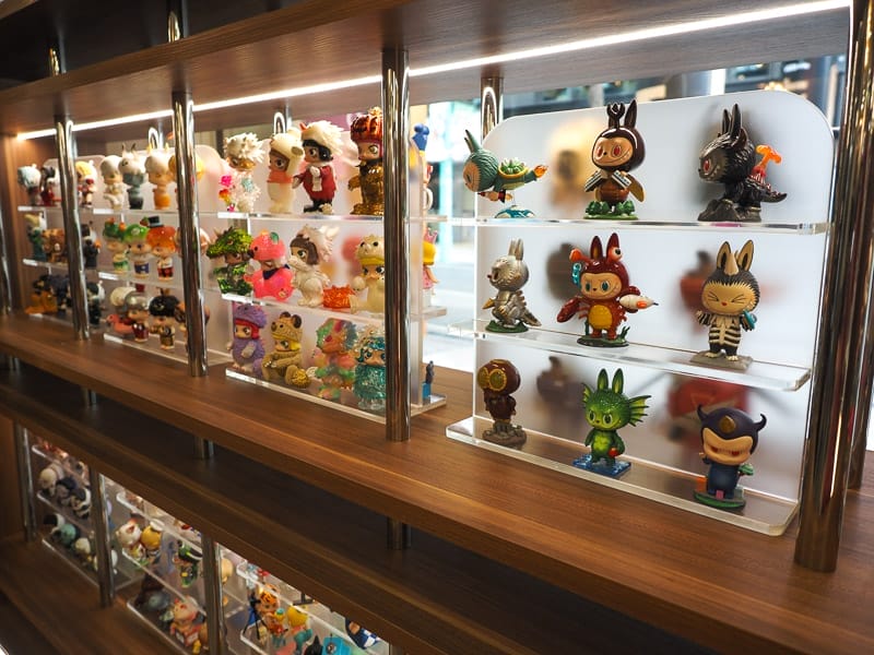 Several lit up shelves of collectible figures of cartoon characters