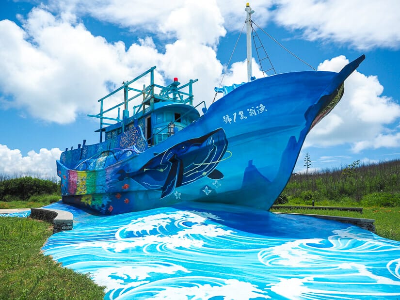 A large colorful ship statue called Xiyu Landmark