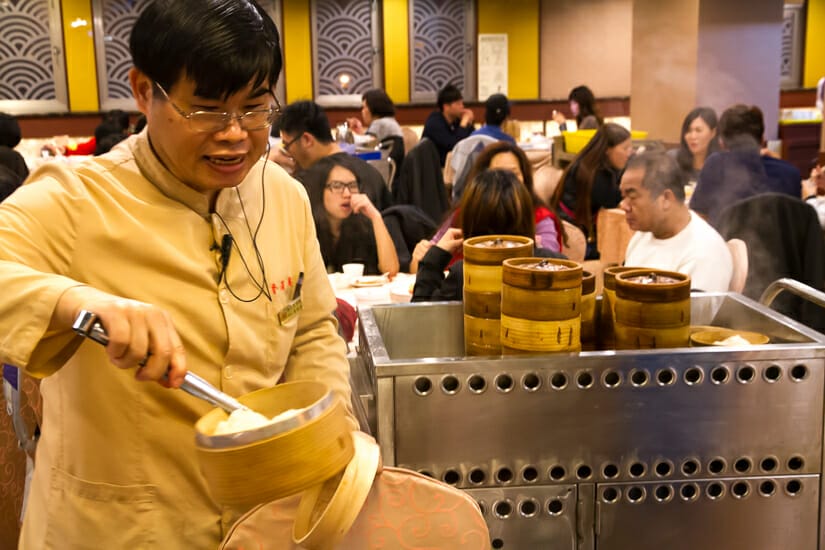 A server handing out food at a dim sum restaurant in Taipei