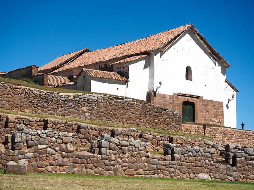 White Spanish-built church on top of stone walls of Inca ruins at Chinchero