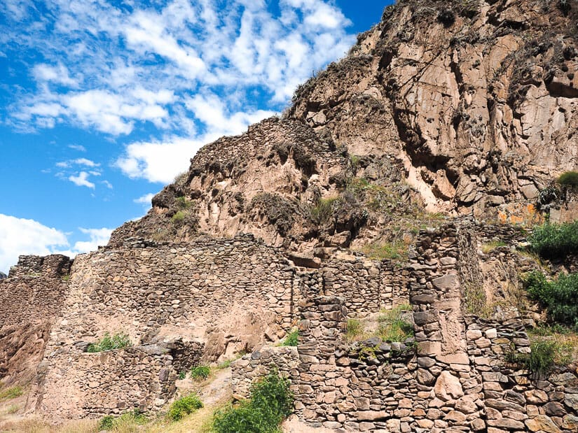 Stone ruins of Chocana built into a cliff with blue sky above