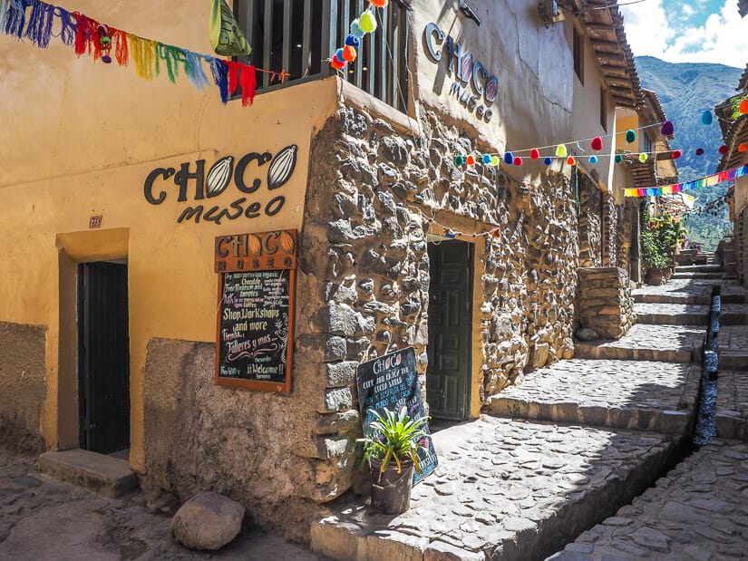 Exterior of ChocoMuseo in Ollantaytambo, with a canal running down the stone street outside