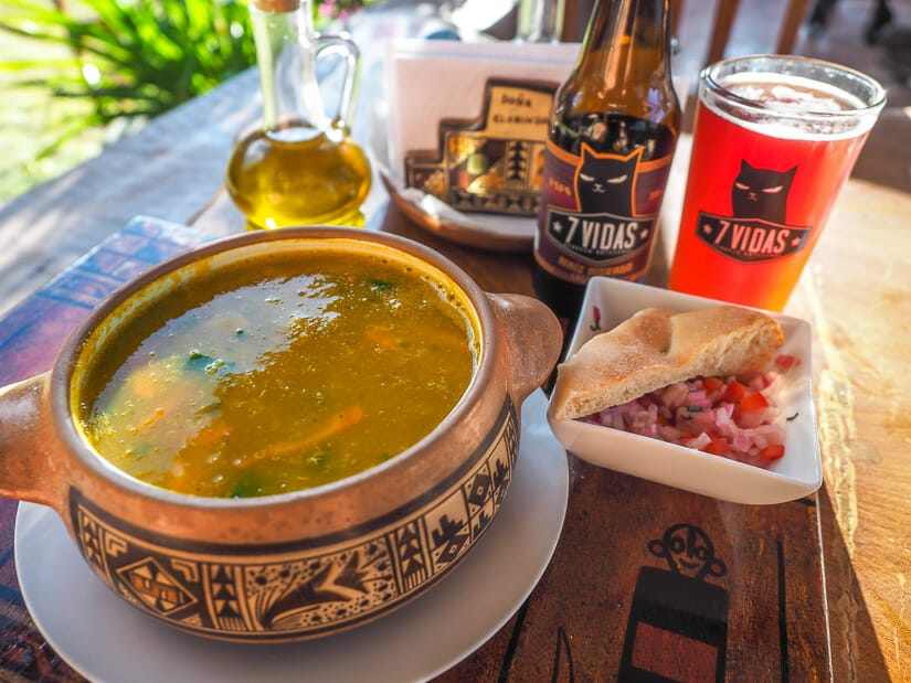 A close up of quinoa soup and craft beer in Restaurante Dona Clorinda in Pisac