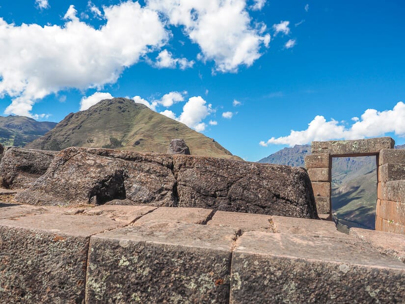 Close up of the Intiwatana stone at Pisac and a stone doorway behind it