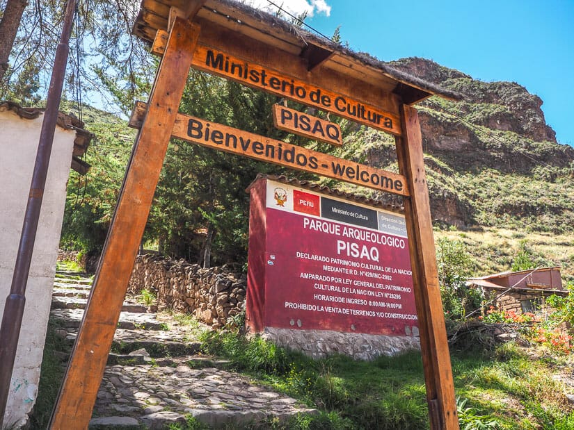 Entrance gate and sign to Pisac ruins, with stairs going up