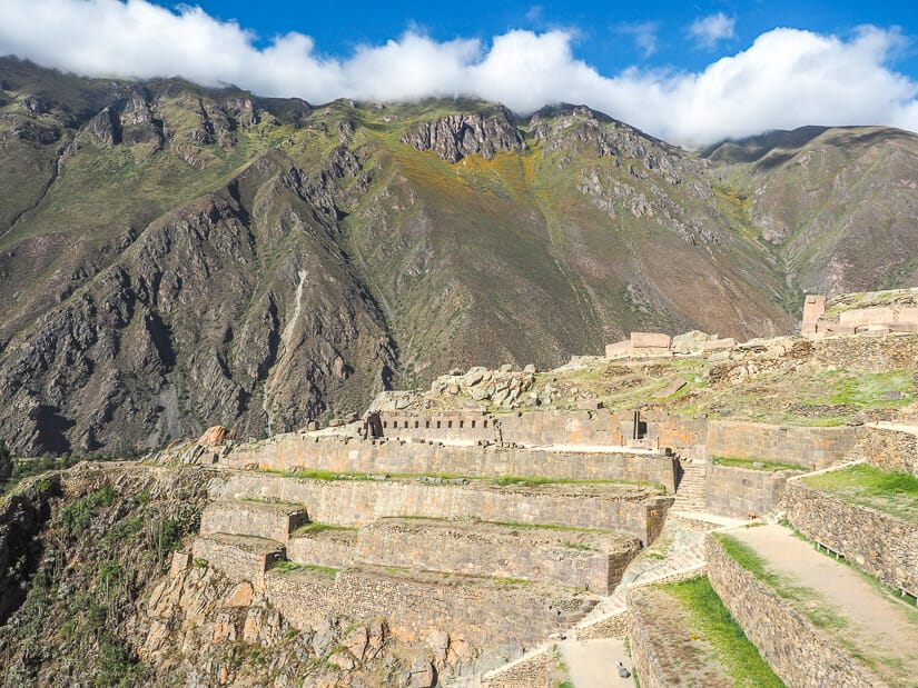View of the main ruins of Ollantaytambo with mountains and blue sky above them