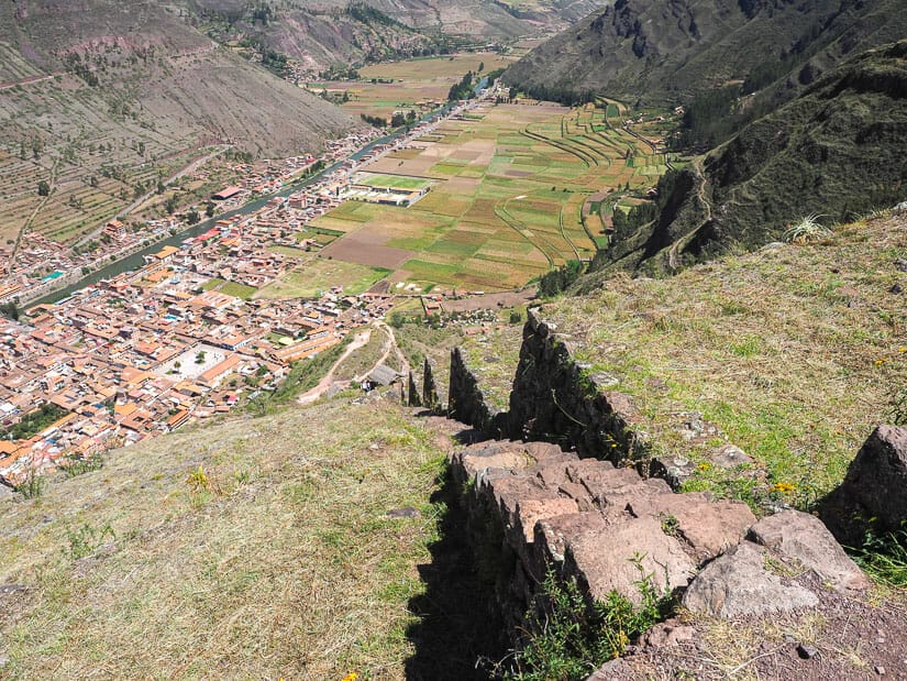 Looking down a steep stone staircase through the terraces at Pisac ruins