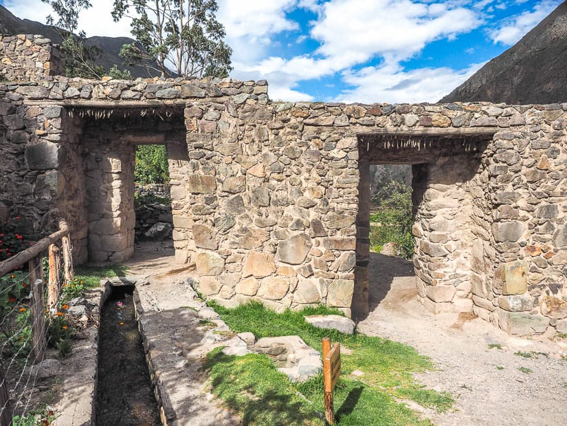 A stone double gate with canal leading up to it right at the entrance to Ollantaytambo town