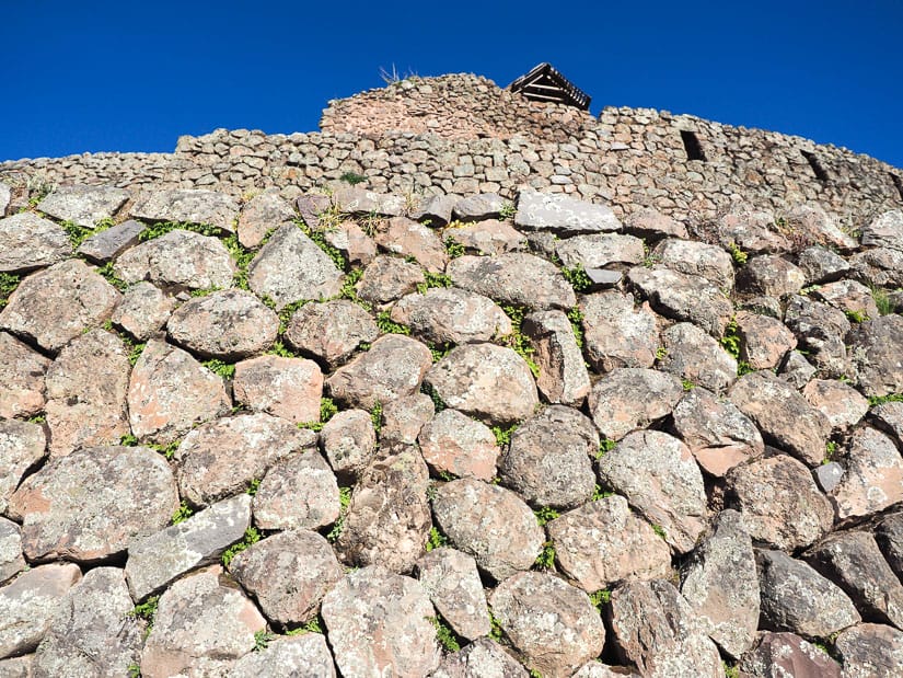 Looking up at a multi-tiered stone wall at Pisac ruins