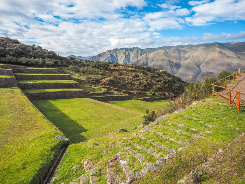 A view of the terraces at Tipon ruins with mountains in the background