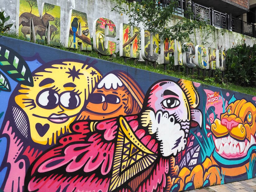 Some colorful street art with a Machu Picchu sign above it