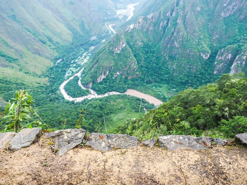 Looking far down at a river from the side of a hiking trail