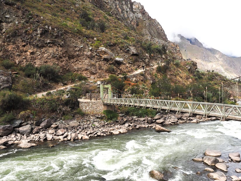 Bridge across the river at the start of the Inca Trail, with the trail visible on the opposite side.