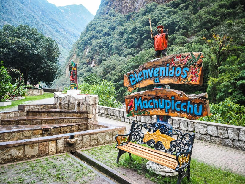 A bench with "Bienvenidos Machu Picchu" written on it in Parque Mirador Río Vilcanota