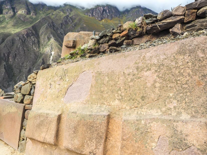 Three rectangular protuberances in a pink granite stone around the corner from the Temple of the Sun