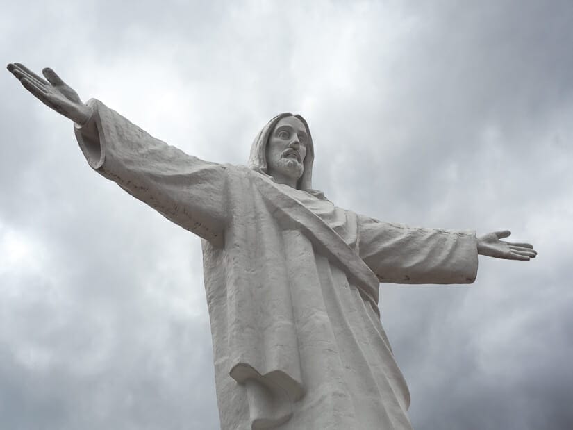 Close up of a white Jesus statue with arms outstretched