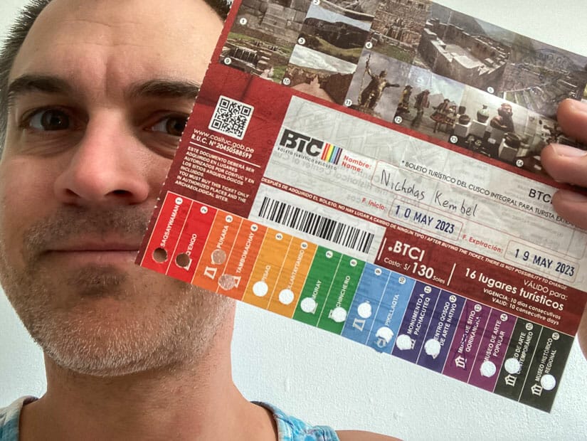 Nick Kembel holding up a Cusco Boleto Turistico with all the attractions stamped on it