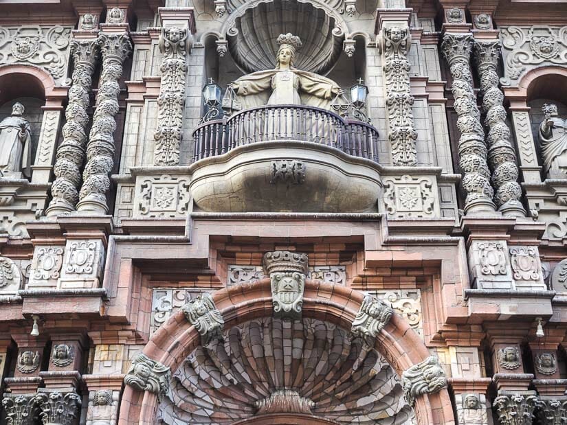 Ornate facade of Iglesia de la Merced with Virgin Mary spreading her arms