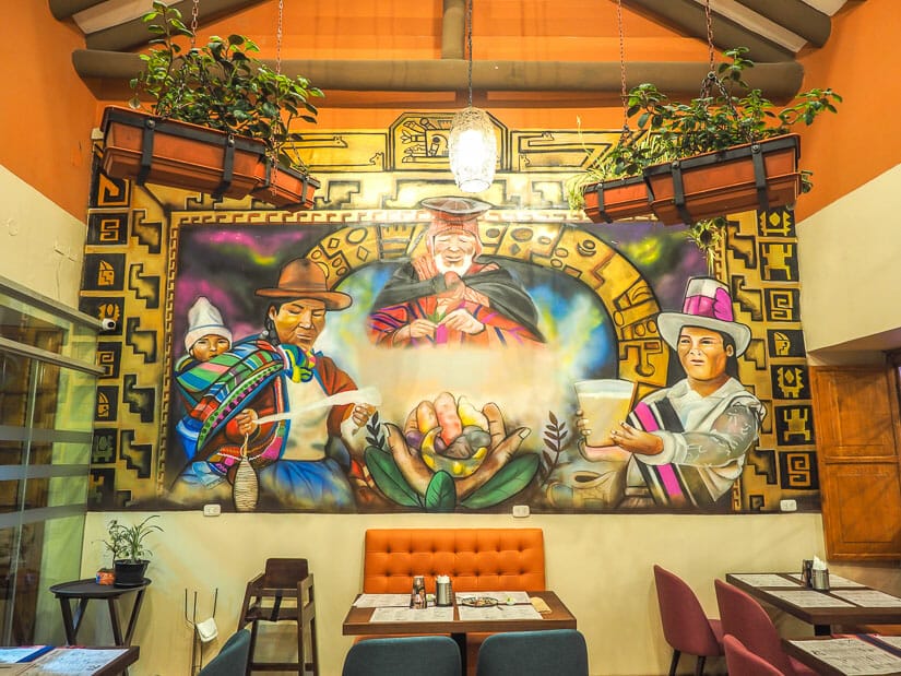 Large indigenous painting on the wall inside Kusykay restaurant