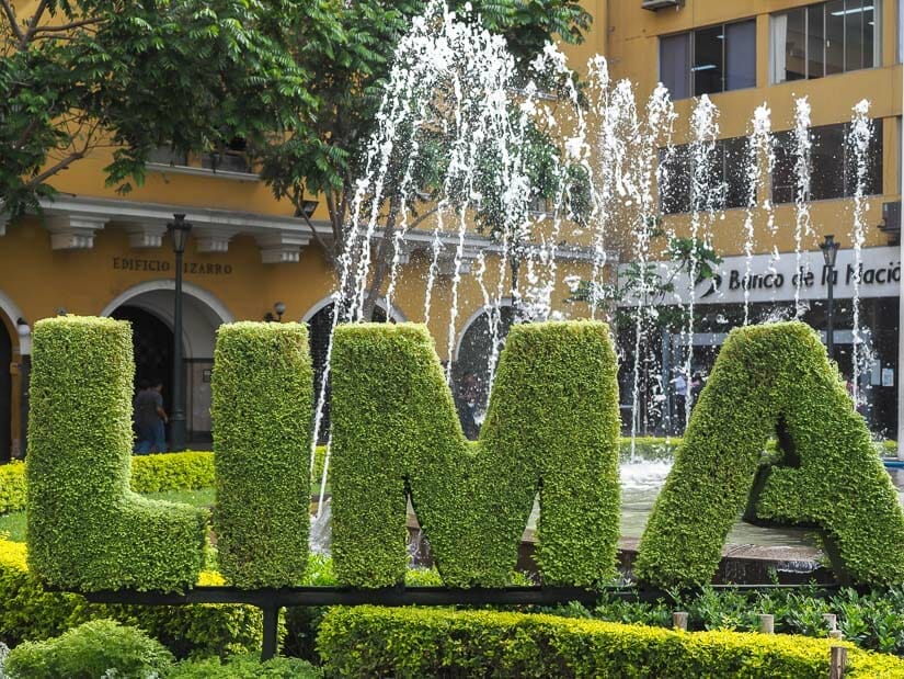 LIMA spelled with leaves and water fountains behind it