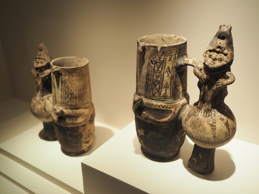 Two Inca drinking cups on display in a museum
