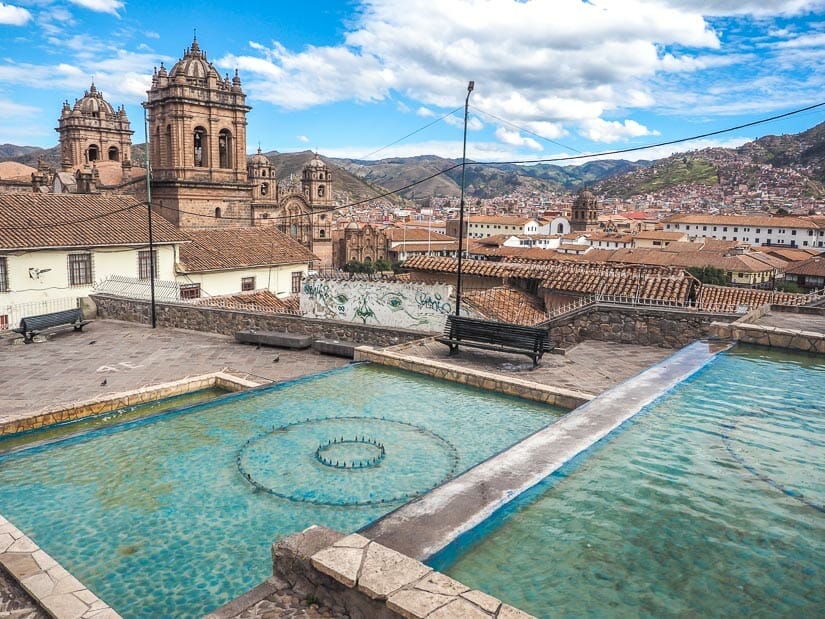 A water fountain and Cusco Cathedral in background