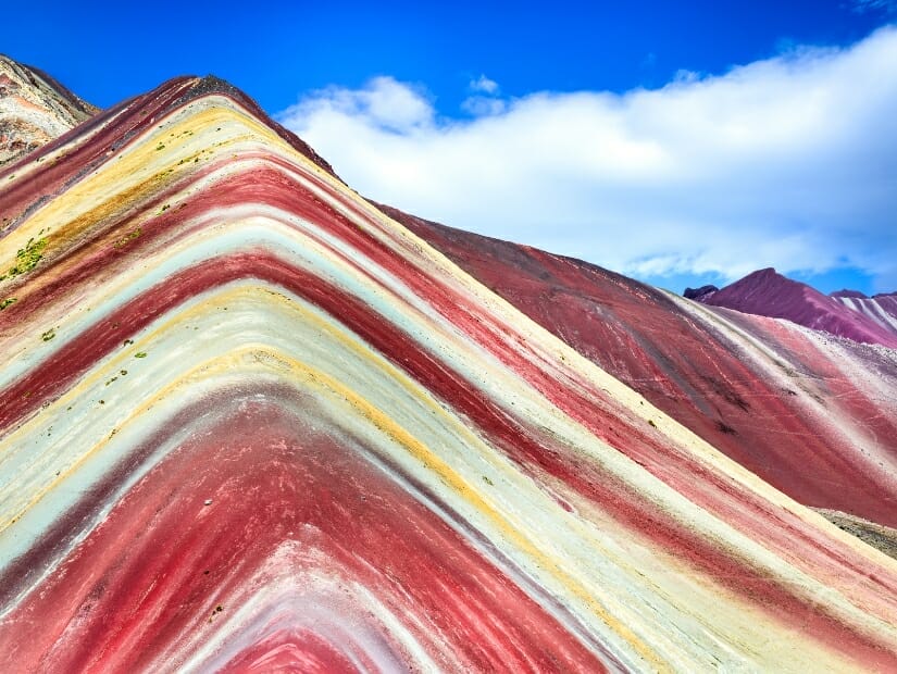 A mountaintop with vibrant stripes of color on it