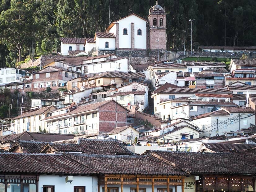 A cluster of houses in Cusco with San Cristobal church at the top